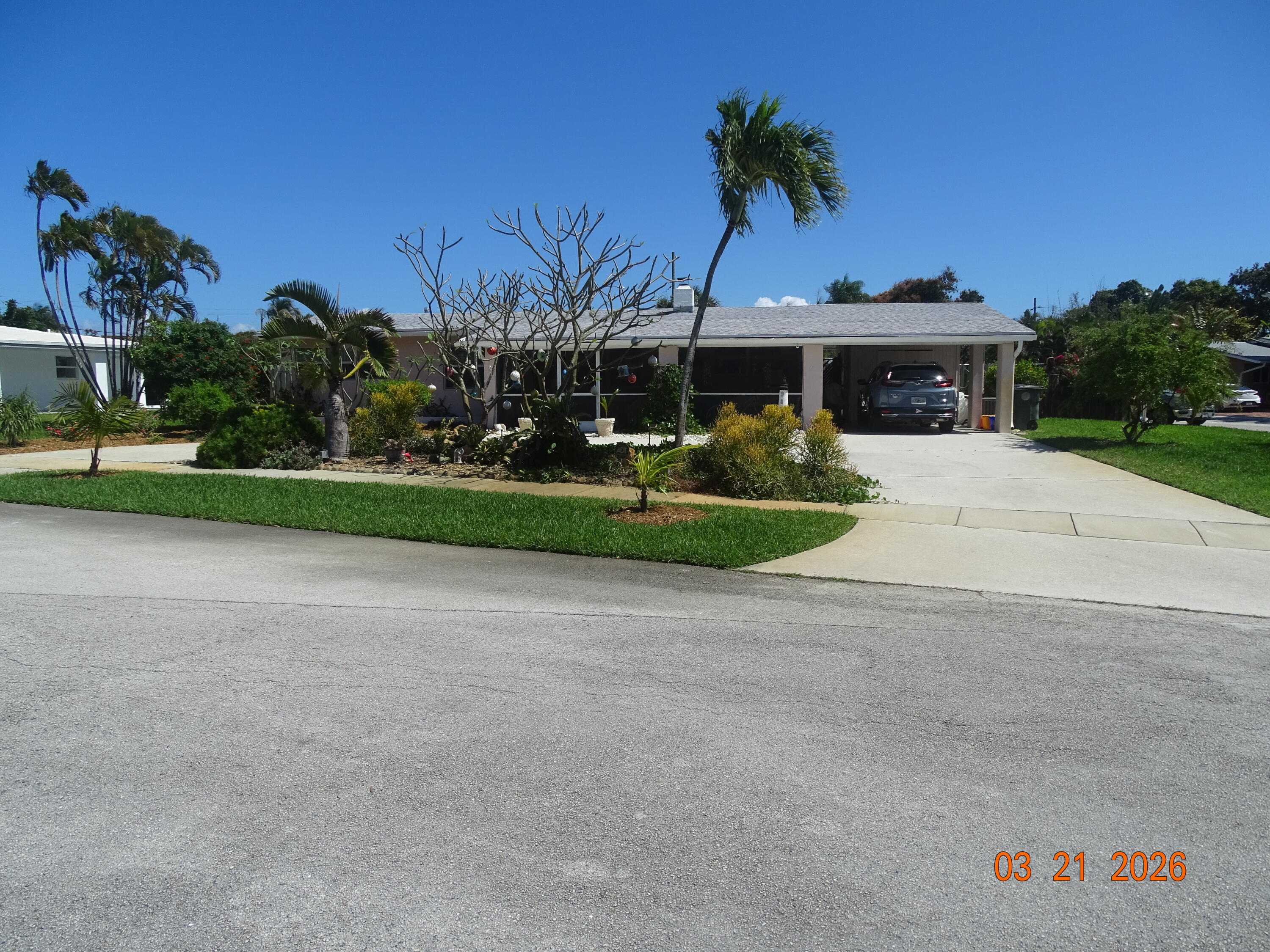 4760 Northwest 2nd Terrace Boca Raton, FL 33431 - Photo 2 of 25 a front view of a house with a yard and outdoor seating