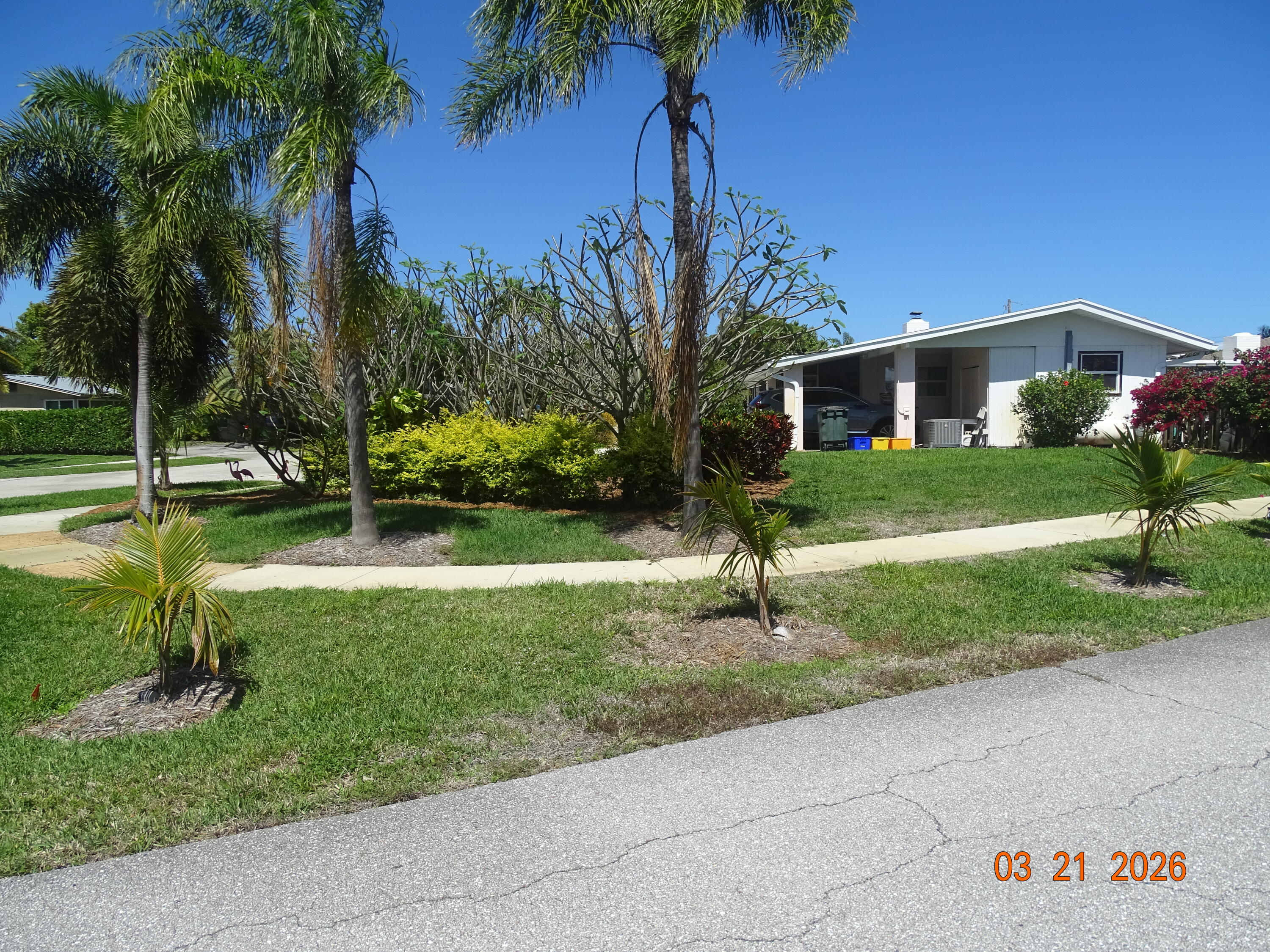 4760 Northwest 2nd Terrace Boca Raton, FL 33431 - Photo 4 of 25 a front view of a house with a yard