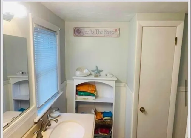 a bathroom with a toilet sink and mirror