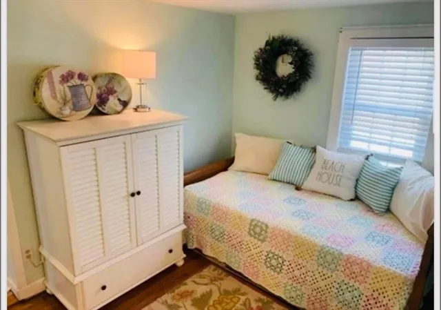 a bedroom with a bed and a white walk in closet