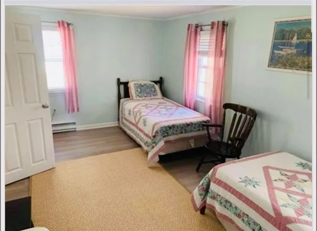 a bedroom with a bed and a chair