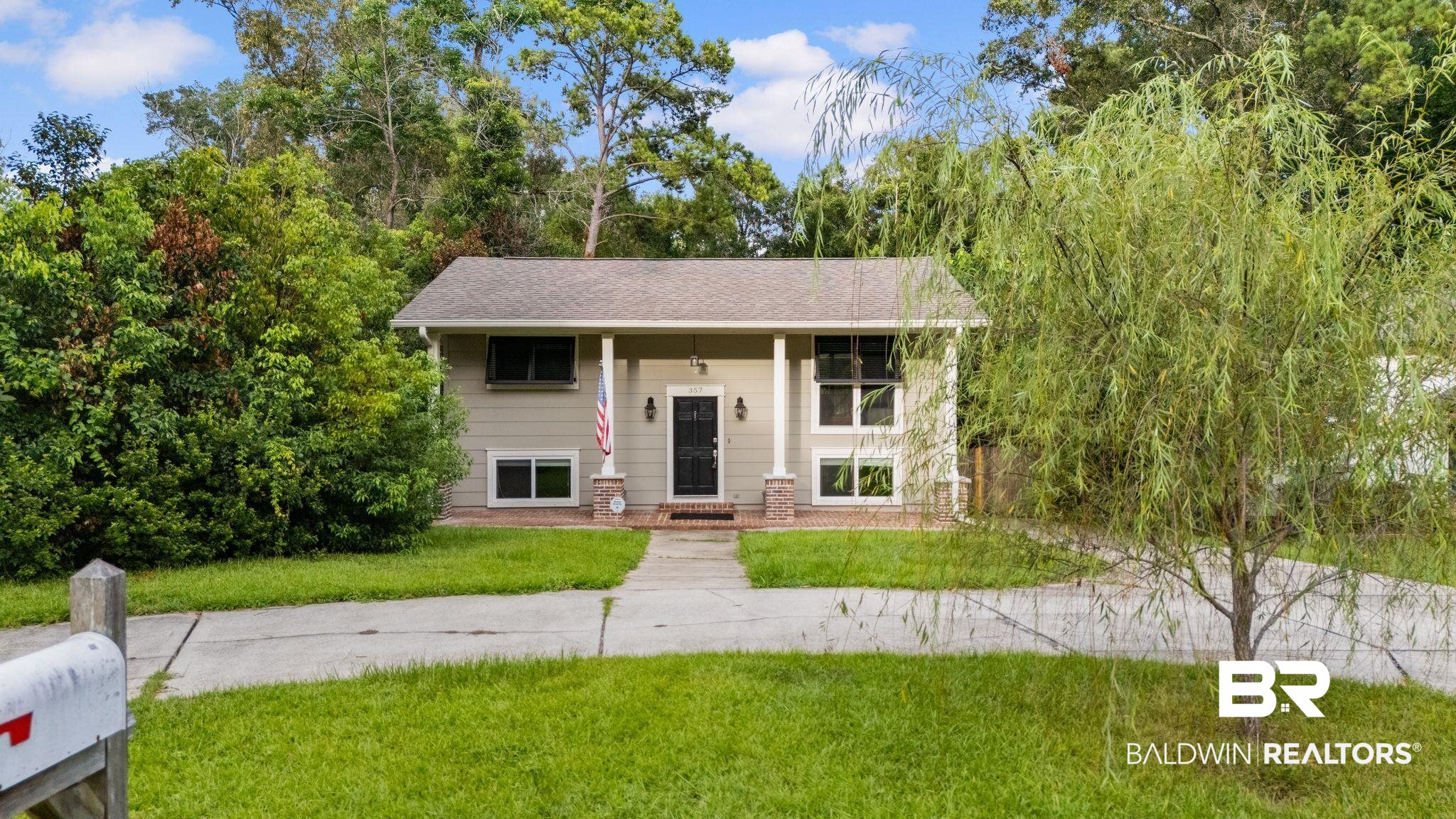 357 South School Street Fairhope, AL 36532 - Photo 2 of 44 Split-level residence featuring a light-colored exterior and a dark entry door