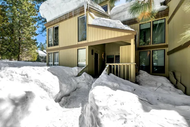 a view of a house with a snow in the background