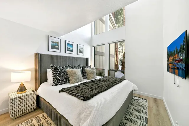 a bedroom with a bed a mirror and desk