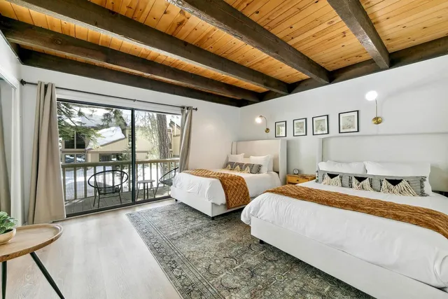 a bedroom with bed and a large window