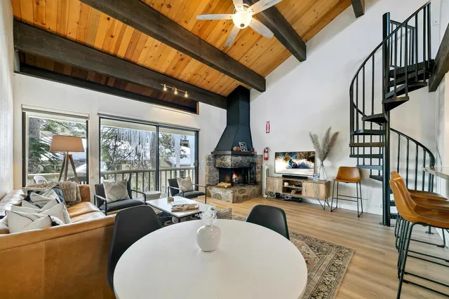 a living room with fireplace furniture and a large window