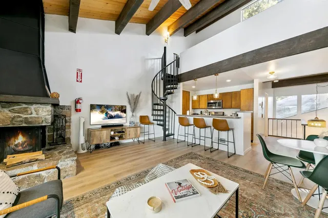 a living room with furniture a fireplace and a flat screen tv