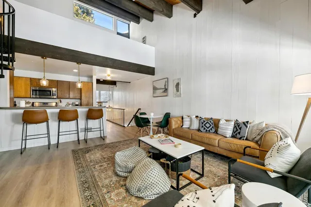 a living room with furniture kitchen view and a table