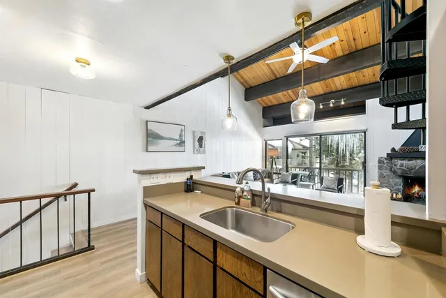 a kitchen with stainless steel appliances granite countertop a sink and a wooden floors