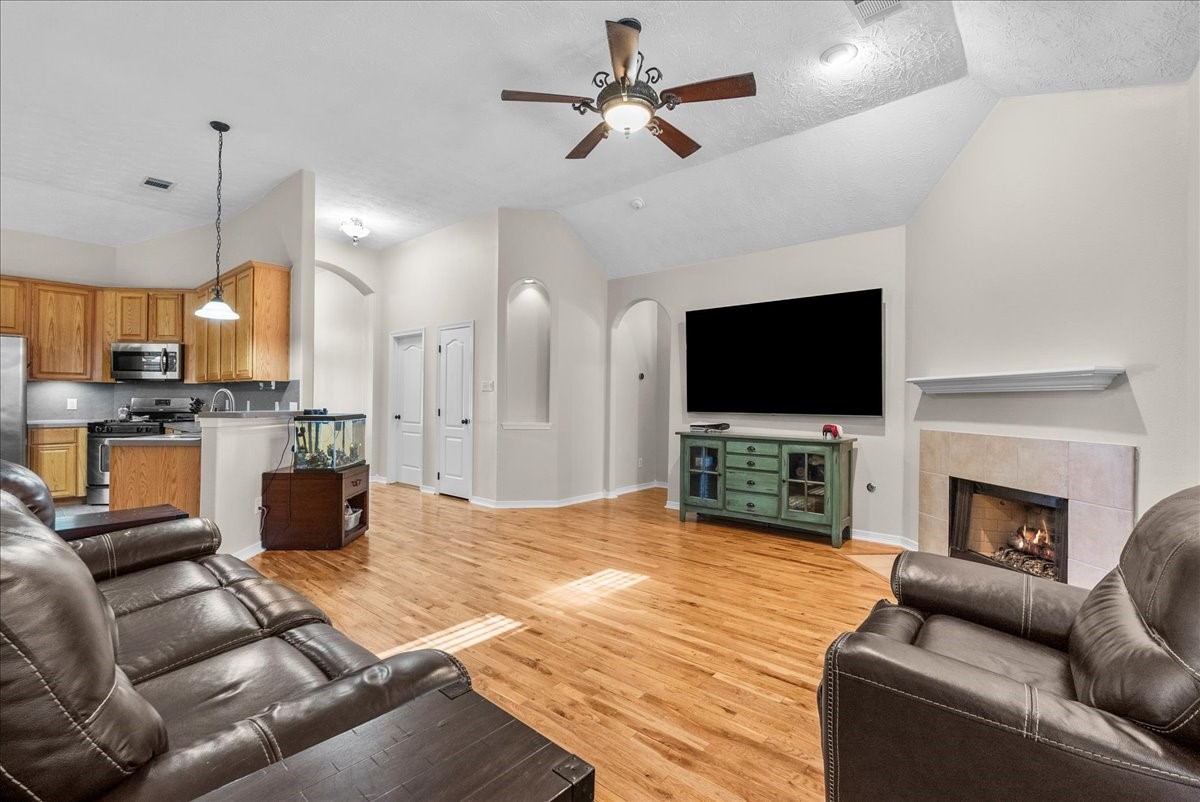 8102 Pinewood Park Humble, TX 77346 - Photo 14 of 37 a living room with fireplace furniture and a flat screen tv