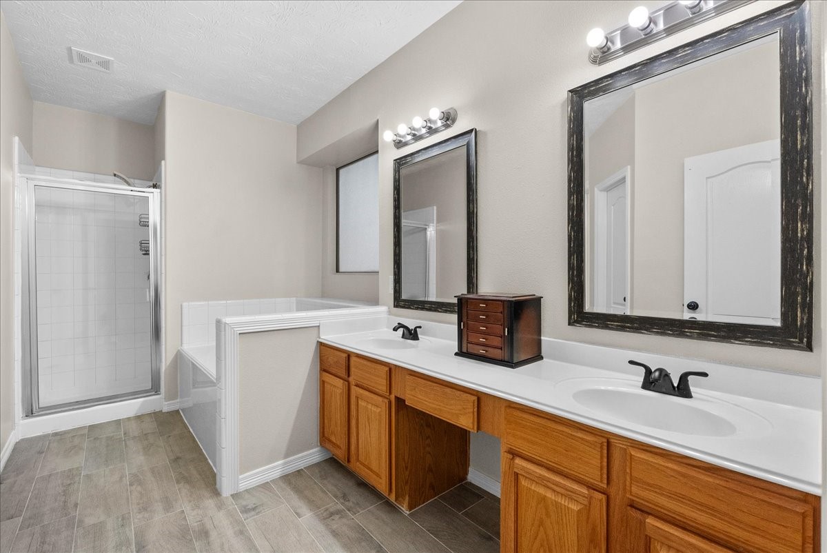 8102 Pinewood Park Humble, TX 77346 - Photo 19 of 37 a bathroom with a double vanity sink and mirror