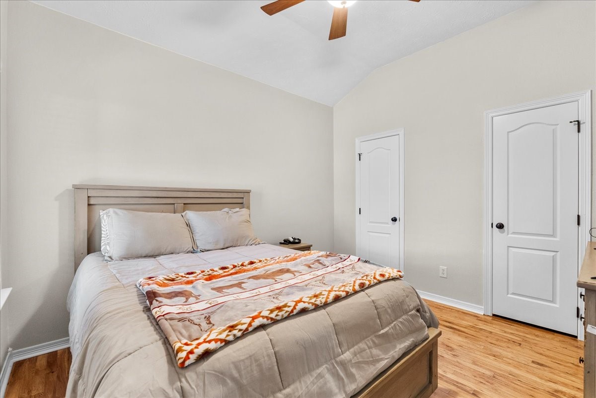 8102 Pinewood Park Humble, TX 77346 - Photo 21 of 37 a bedroom with a bed and wooden floor