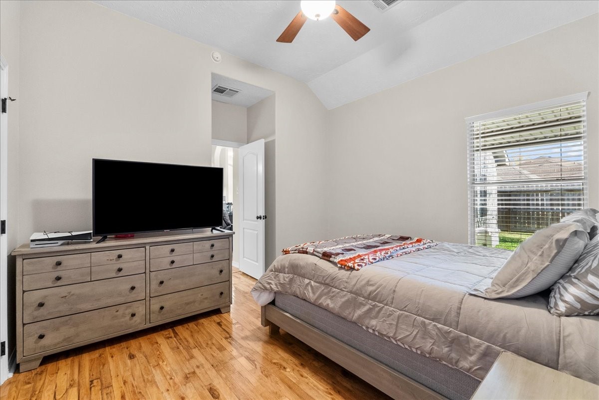 8102 Pinewood Park Humble, TX 77346 - Photo 22 of 37 a bedroom with a bed and a flat screen tv