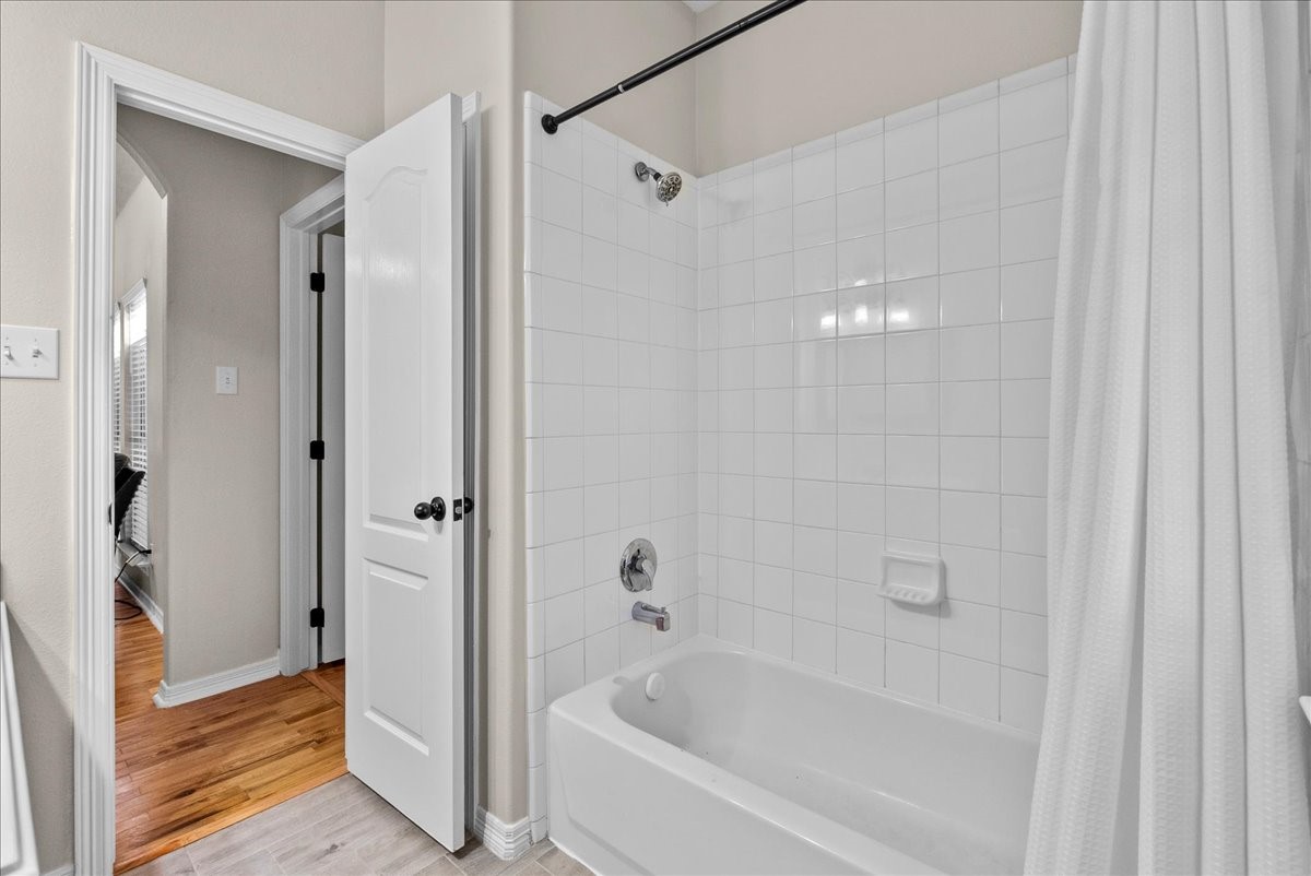 8102 Pinewood Park Humble, TX 77346 - Photo 26 of 37 a bathroom with a bathtub and a shower