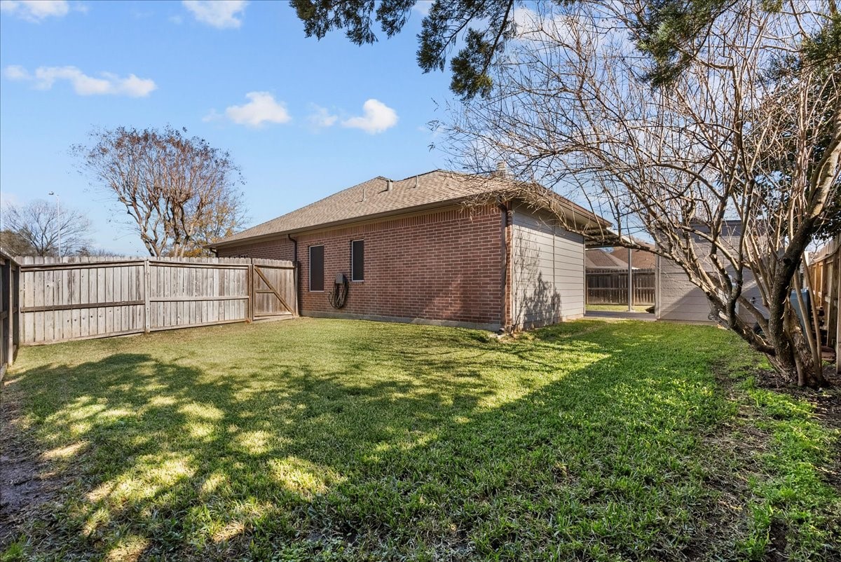 8102 Pinewood Park Humble, TX 77346 - Photo 31 of 37 a view of a house with a yard