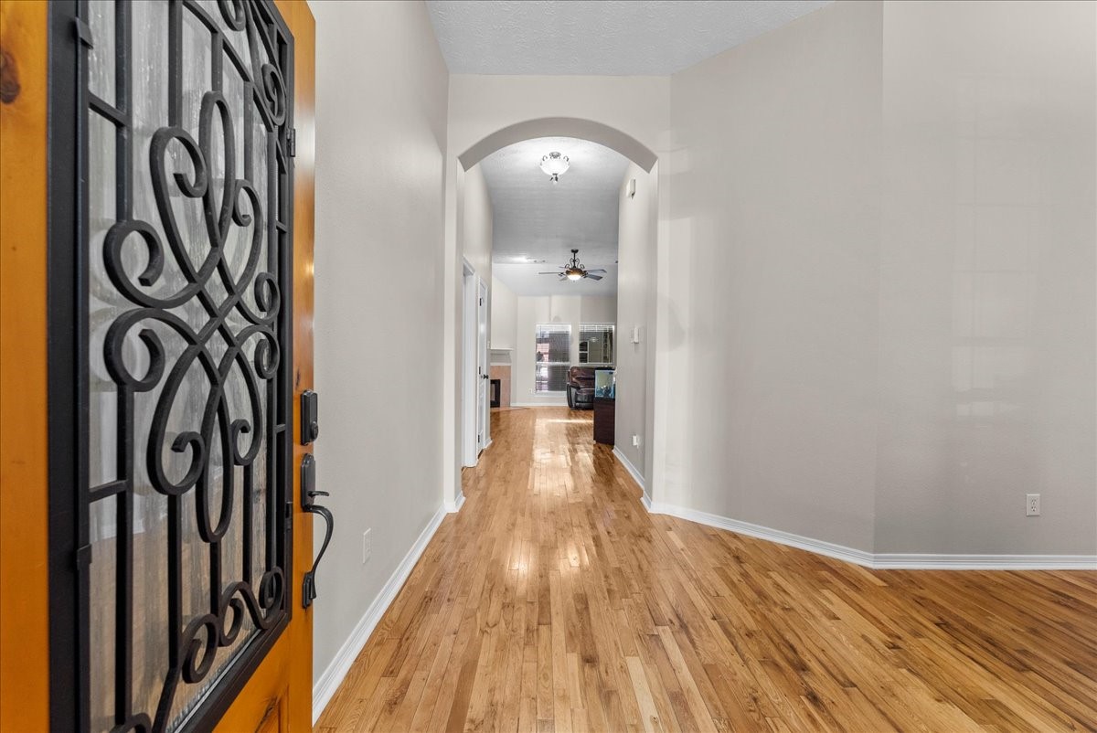 8102 Pinewood Park Humble, TX 77346 - Photo 4 of 37 a view of a hallway with wooden floor