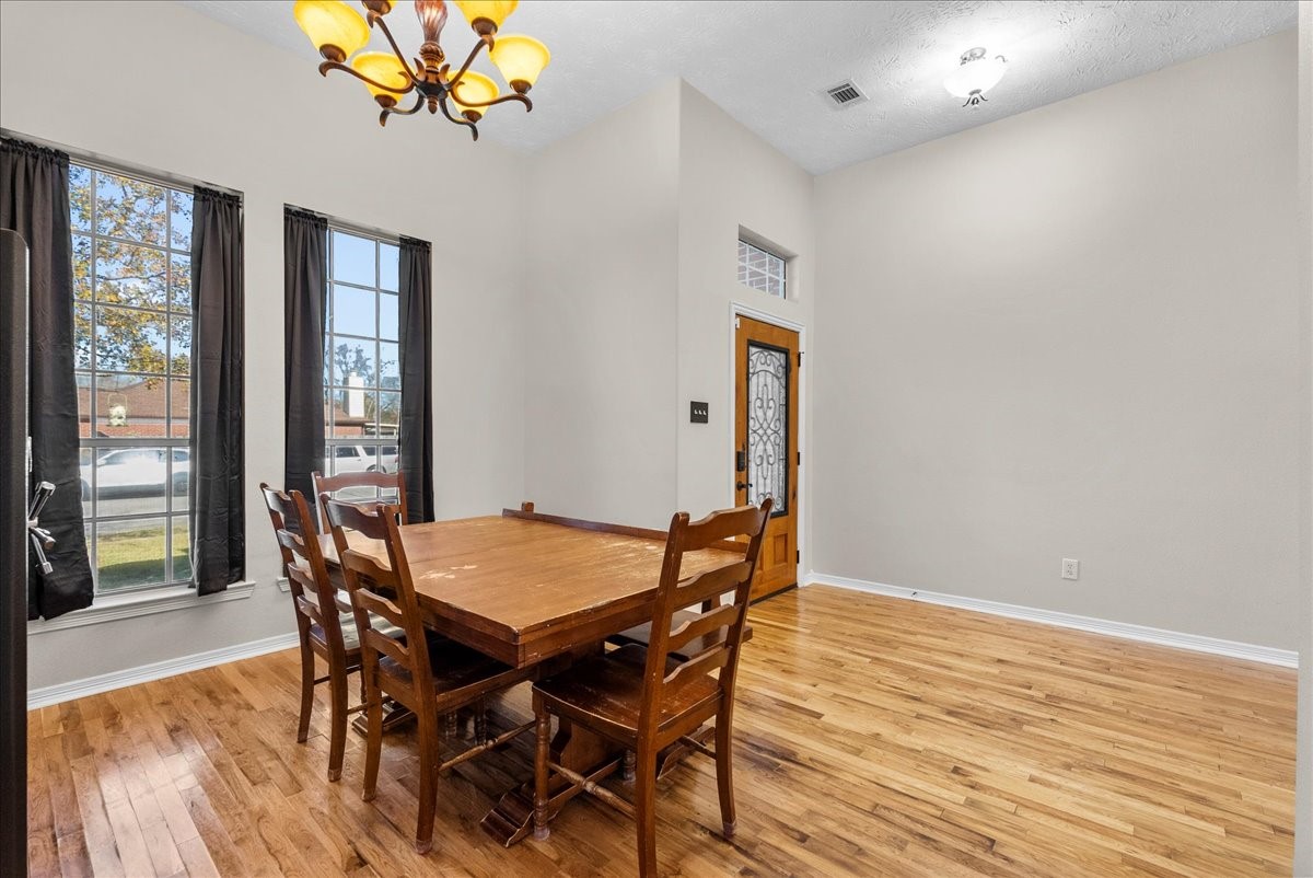 8102 Pinewood Park Humble, TX 77346 - Photo 5 of 37 a view of a dining room with furniture wooden floor and chandelier