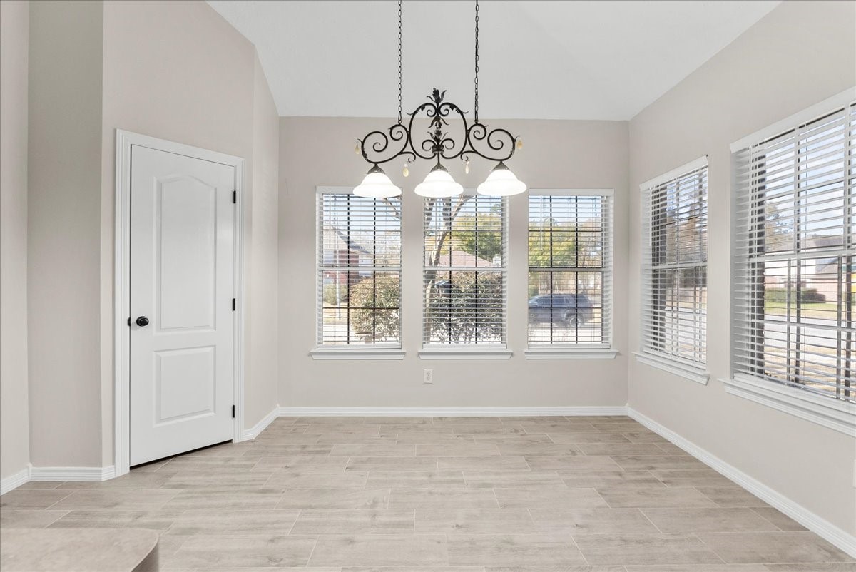 8102 Pinewood Park Humble, TX 77346 - Photo 7 of 37 a view of an empty room with wooden floor and windows