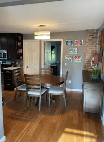 a dining room with furniture and wooden floor
