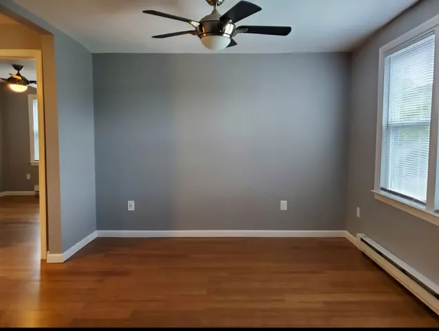 a view of room with window and wooden floor