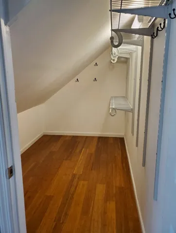 a view of a room with wooden floor