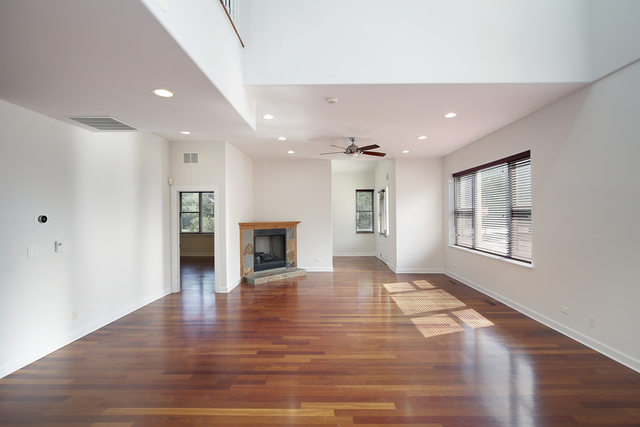 4 Rienzi Lane Highwood, IL 60040 - Photo 4 of 10 a view of empty room with wooden floor and fireplace