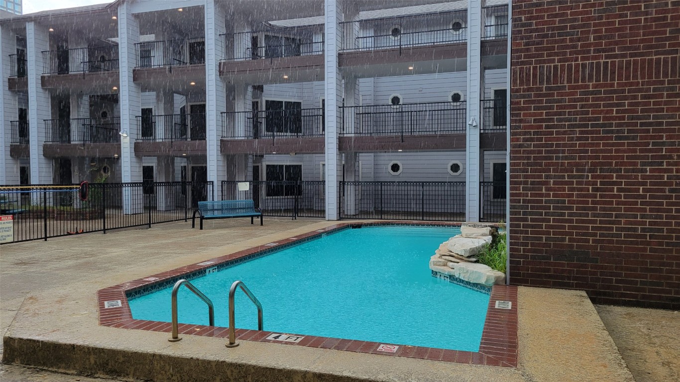 a view of a balcony with yard