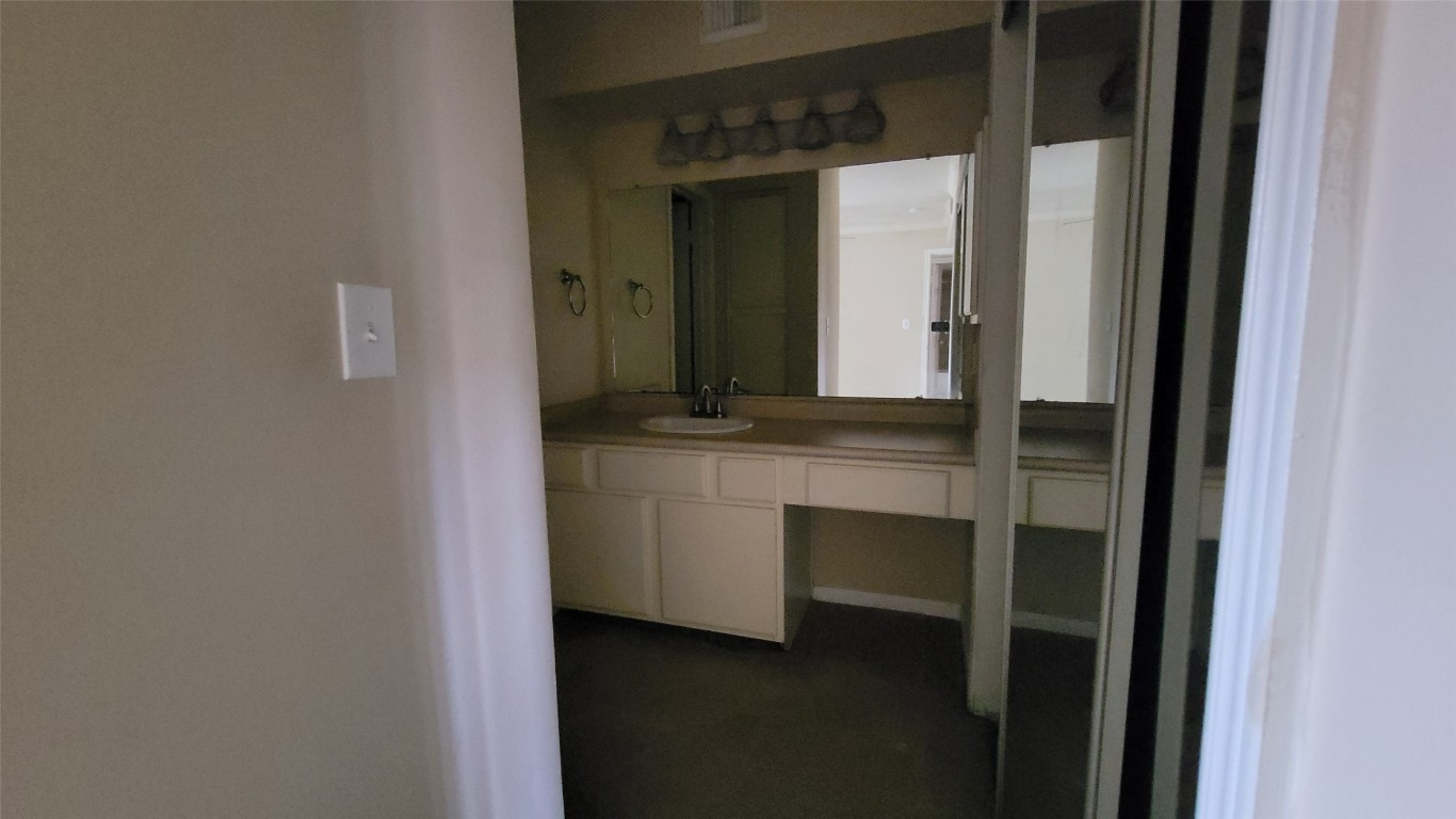 501 West 26th Street, Unit 120 Austin, TX 78705 - Photo 2 of 10 a bathroom with a sink and a mirror