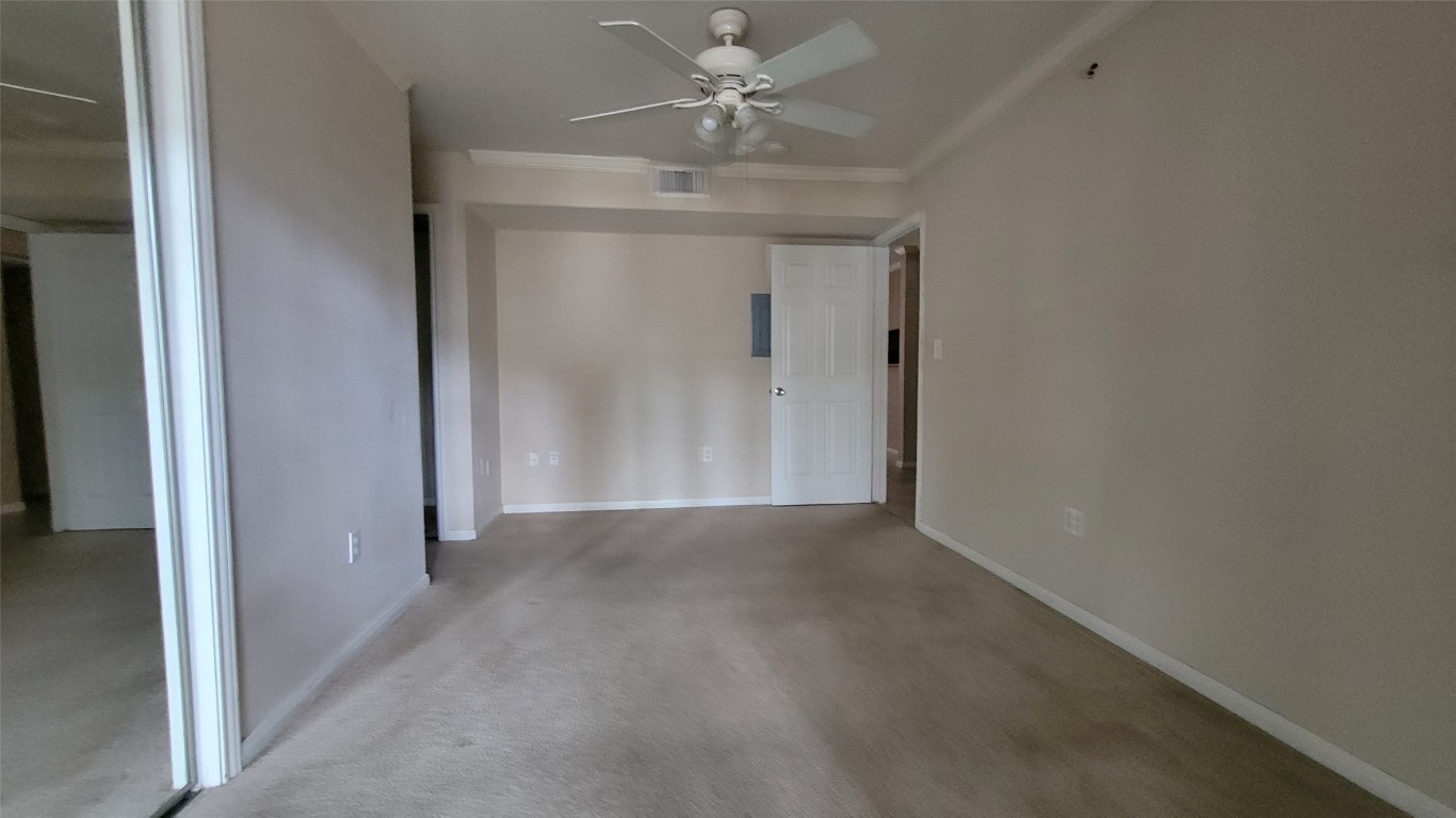 501 West 26th Street, Unit 120 Austin, TX 78705 - Photo 3 of 10 an empty room with a ceiling fan and a window
