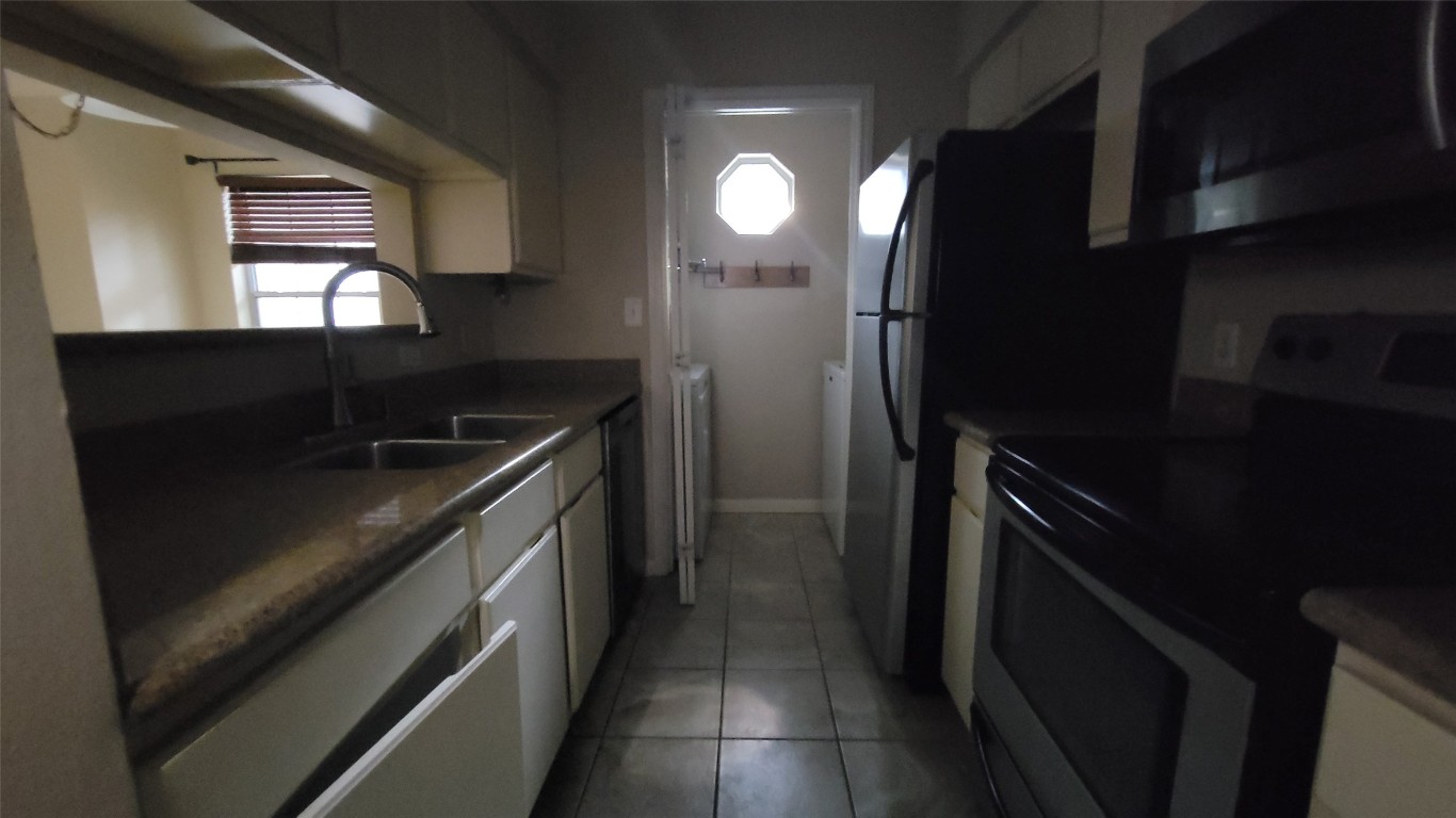 501 West 26th Street, Unit 120 Austin, TX 78705 - Photo 7 of 10 a kitchen with a sink and stainless steel appliances