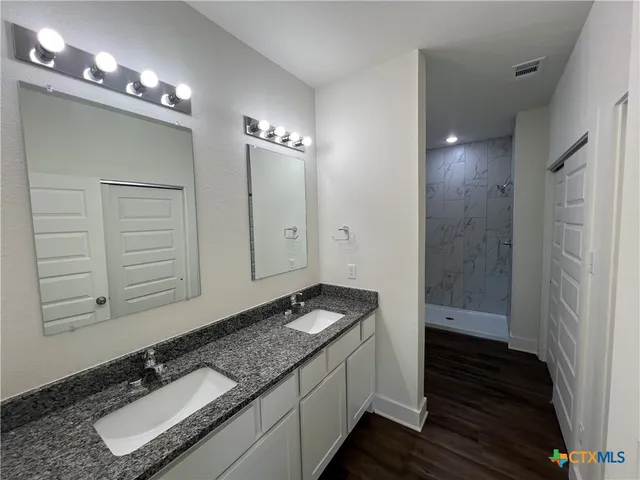 a bathroom with a toilet a sink and shower