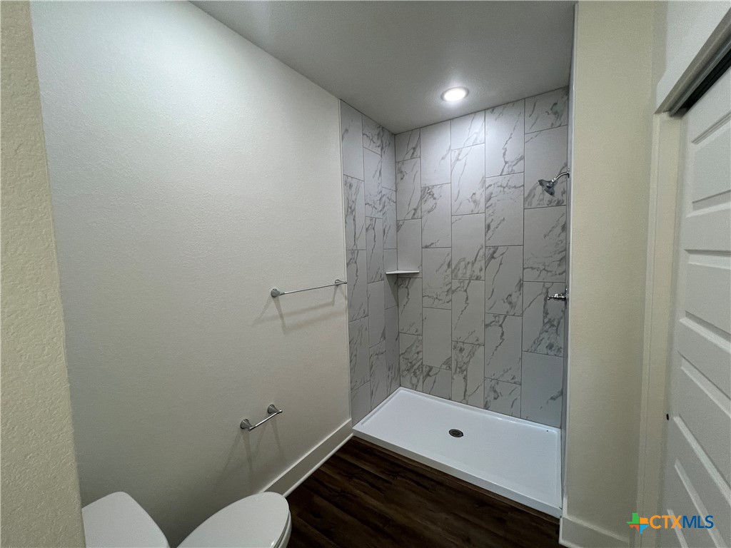 1810 Royal Loop Belton, TX 76513 - Photo 12 of 23 a bathroom with a toilet a sink and shower