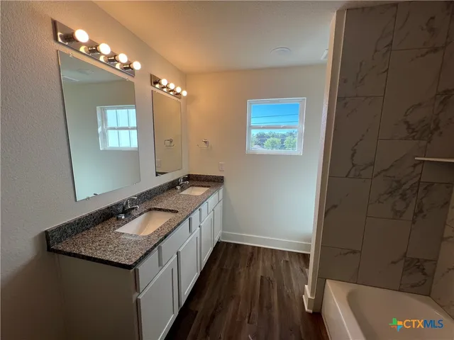 a room with linen closet and wooden floor