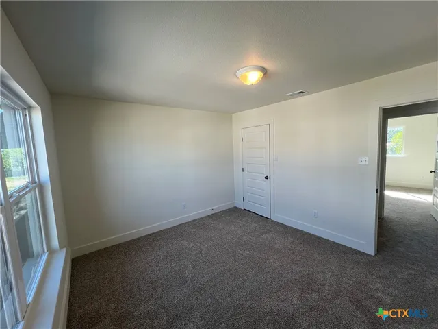 an empty room with a empty space and a window