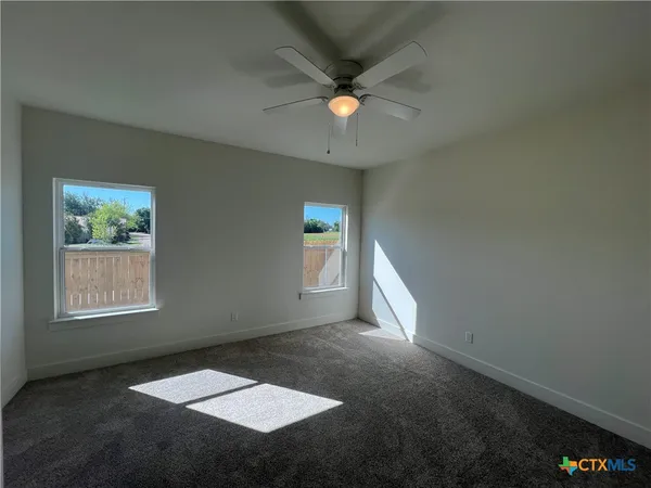 wooden floor in an empty room with a bathroom