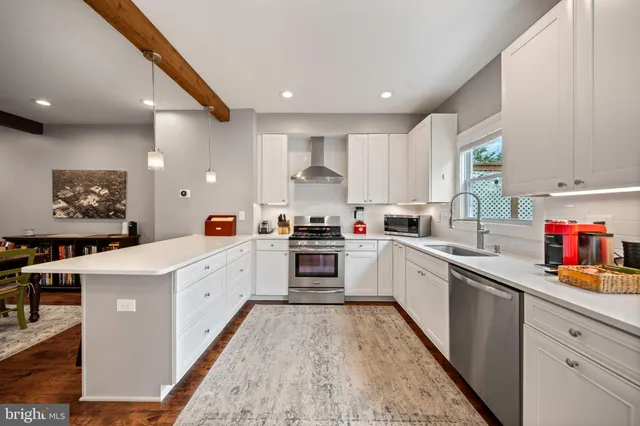 a kitchen with stainless steel appliances granite countertop a stove sink and cabinets