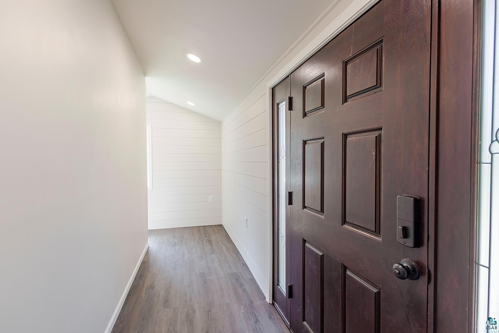 29 Ridge Road Esko, MN 55733 - Photo 6 of 41 Entryway featuring a paneled wood-finish door with sidelight, flush-mount lighting, wood-finish flooring, and shiplap wall paneling