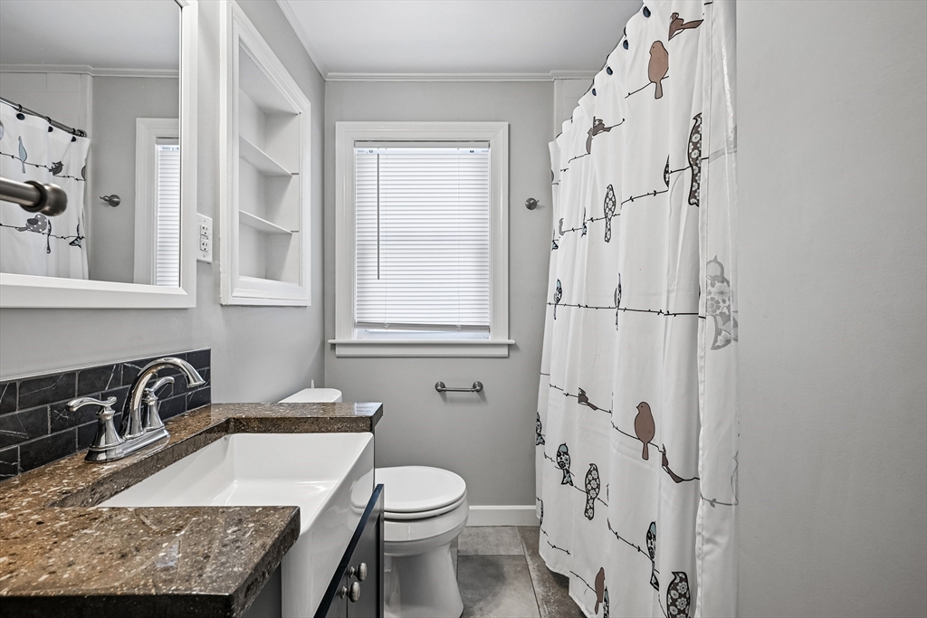 42 East Main Street Gloucester, MA 01930 - Photo 11 of 25 a bathroom with a granite countertop sink toilet and shower