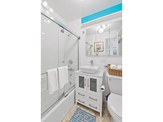a view of an empty room with wooden floor and closet