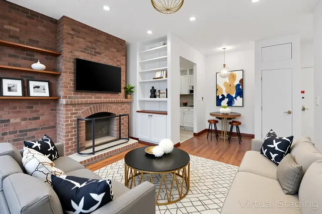 a view of an empty room with a fireplace and a window
