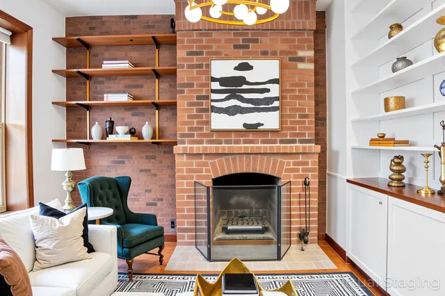 a view of a livingroom with wooden floor and a fireplace