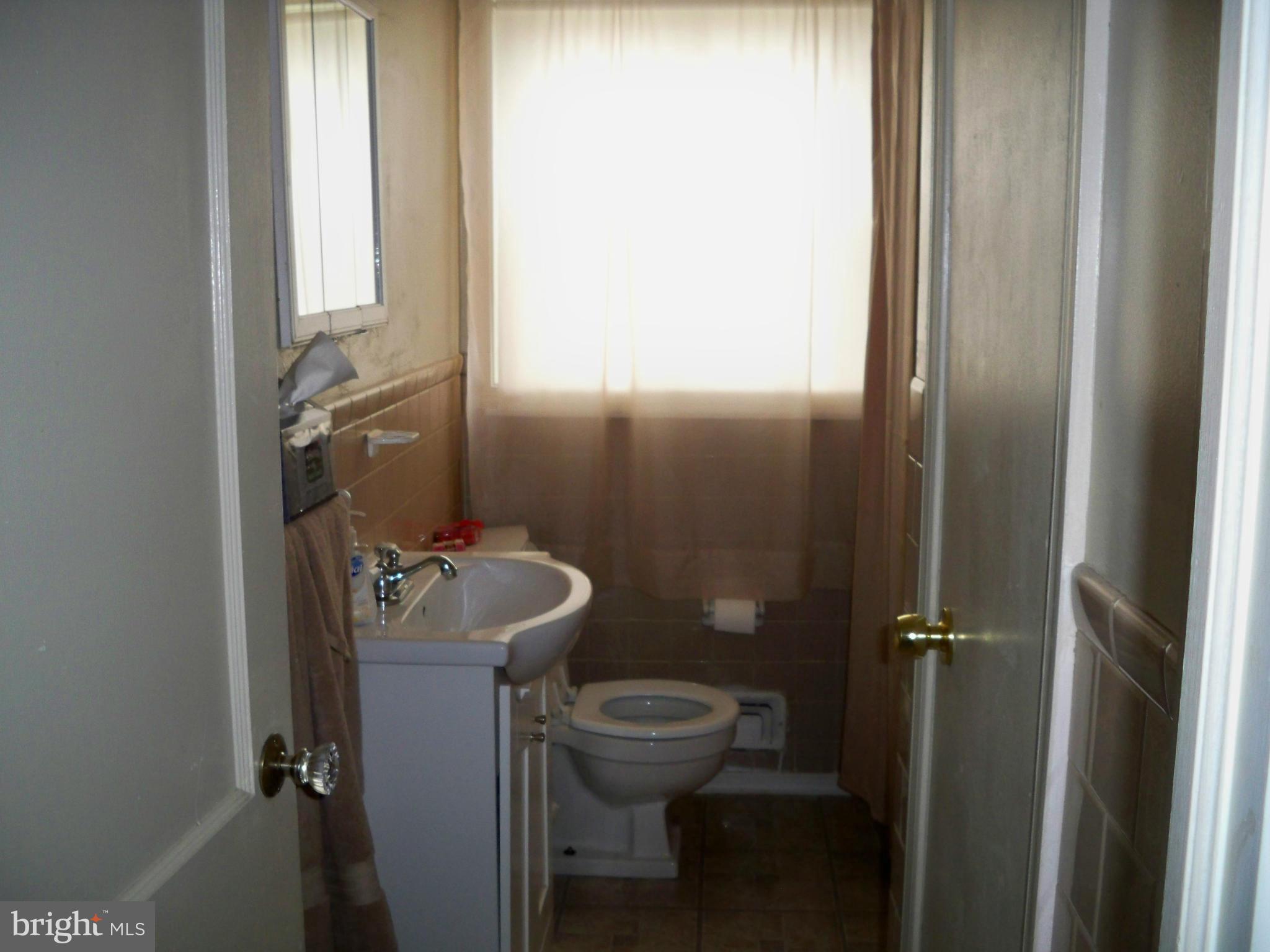 1338 Halstead Road Baltimore, MD 21234 - Photo 14 of 22 a bathroom with a sink a toilet and a mirror