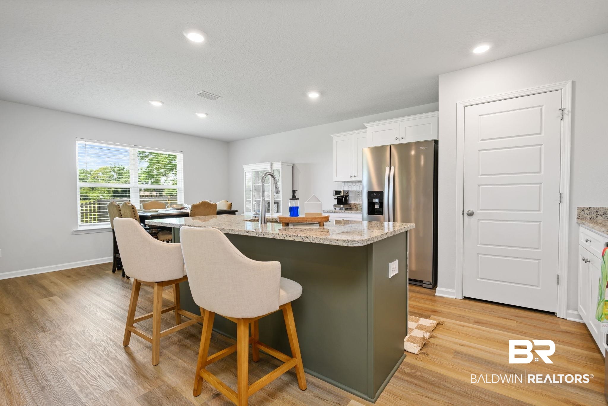 8021 Valor Rdg Way North Mobile, AL 36619 - Photo 25 of 34 Kitchen featuring a central island with a granite countertop and integrated sink, stainless steel appliances, recessed lighting, and wood-finish flooring