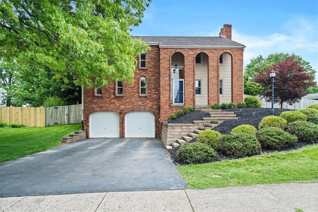 102 Bertley Ridge Drive Coraopolis, PA 15108 - Photo 1 of 24 a front view of a house with a yard and potted plants