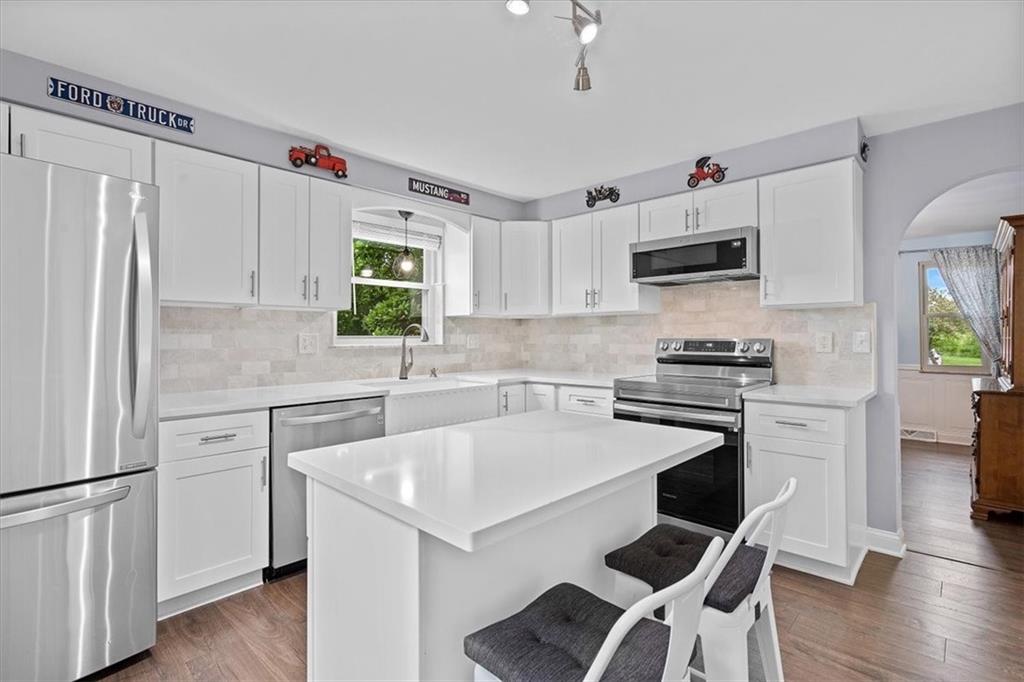 102 Bertley Ridge Drive Coraopolis, PA 15108 - Photo 11 of 24 a kitchen with kitchen island white cabinets and stainless steel appliances