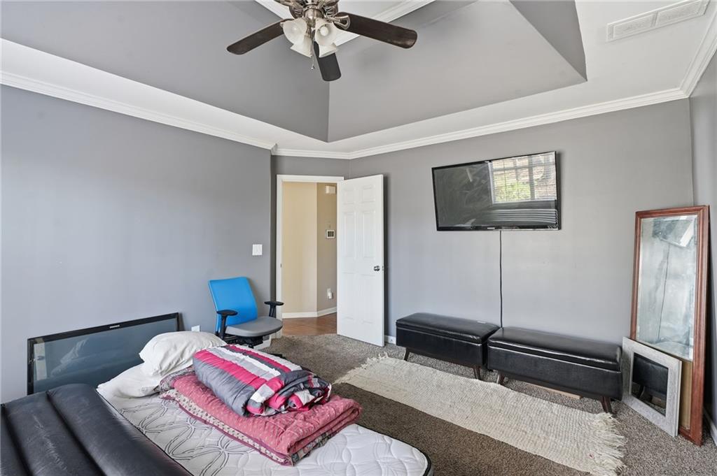 355 Radcliffe Trace Covington, GA 30016 - Photo 12 of 28 a bedroom with furniture and a flat screen tv