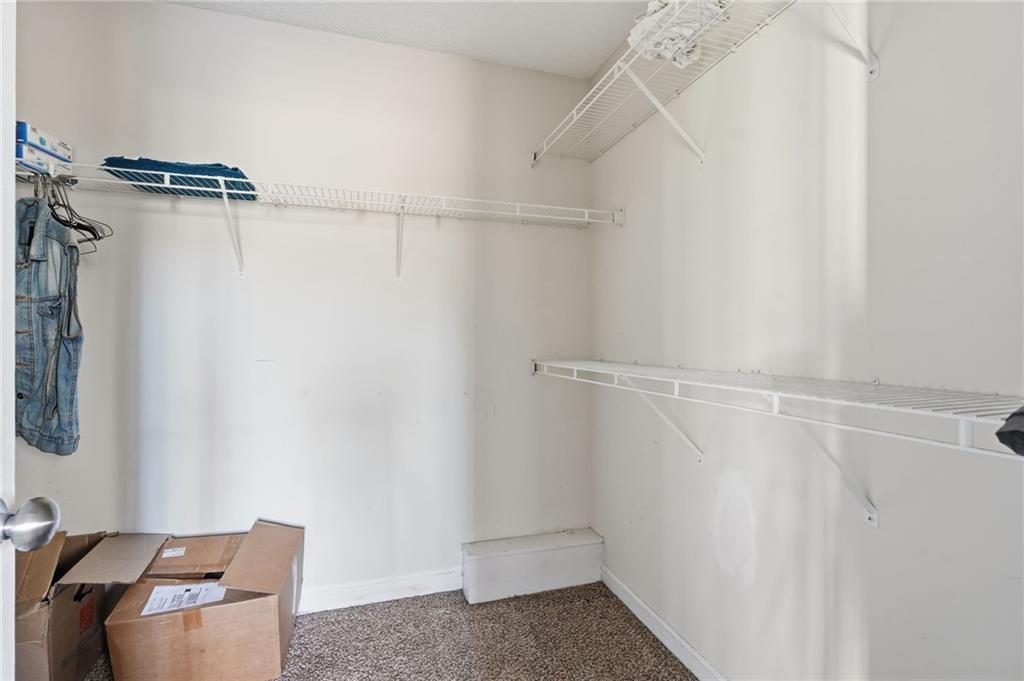 355 Radcliffe Trace Covington, GA 30016 - Photo 14 of 28 a view of walk in closet with clothes