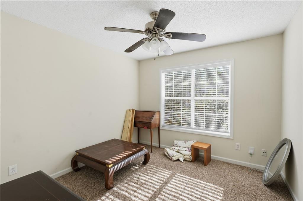 355 Radcliffe Trace Covington, GA 30016 - Photo 21 of 28 a living room with furniture and a window