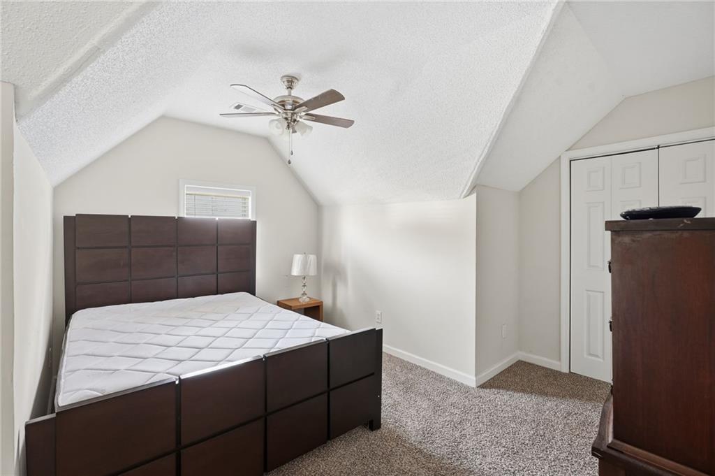 355 Radcliffe Trace Covington, GA 30016 - Photo 23 of 28 a bedroom with a bed and cabinets