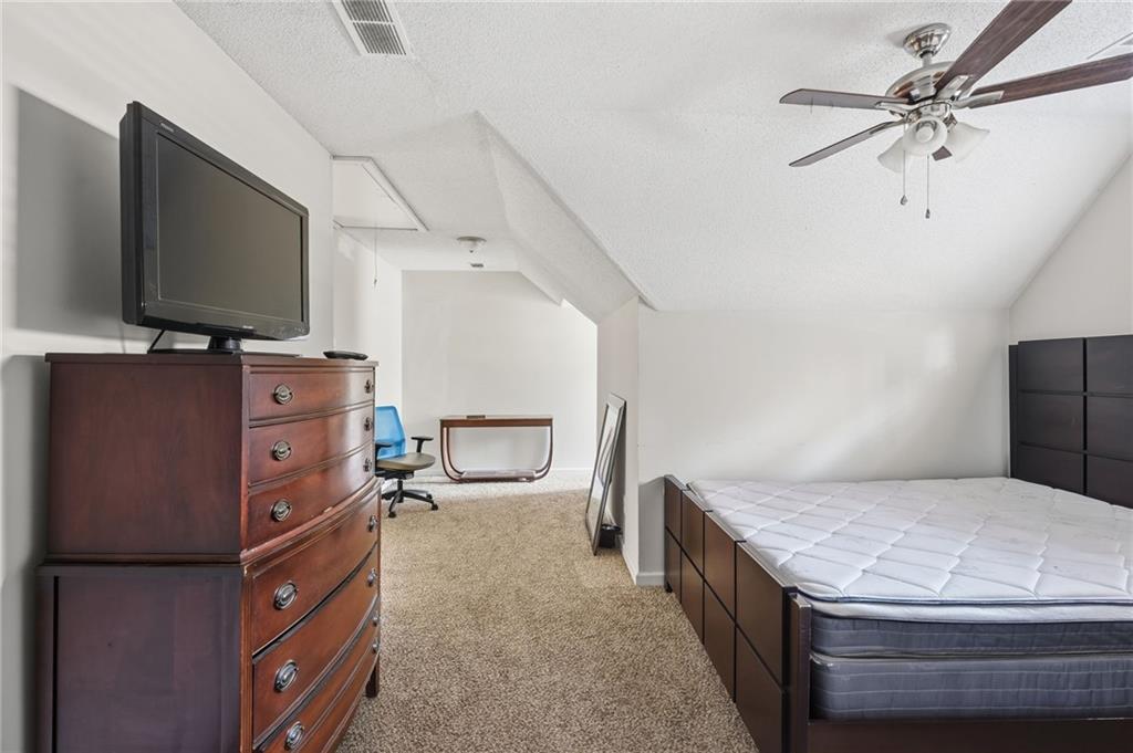 355 Radcliffe Trace Covington, GA 30016 - Photo 24 of 28 a living room with furniture and a flat screen tv